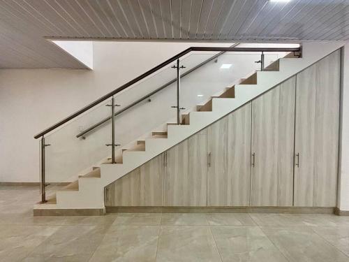 a staircase in a room with wooden cabinets at Casa colonial jacuzzi cerca al parque principal in Santa Fe de Antioquia