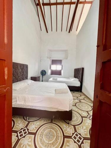 a bedroom with a large bed in a room at Casa colonial jacuzzi cerca al parque principal in Santa Fe de Antioquia