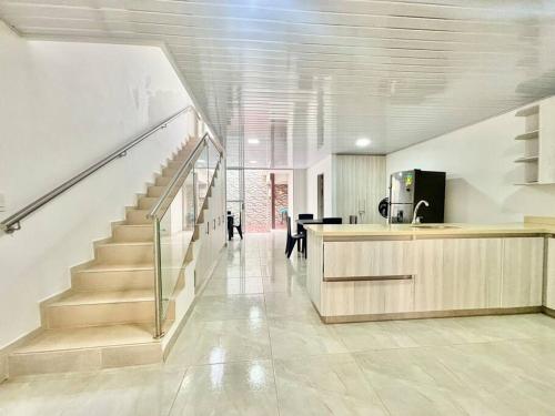 a hallway with a staircase in a house at Casa colonial jacuzzi cerca al parque principal in Santa Fe de Antioquia
