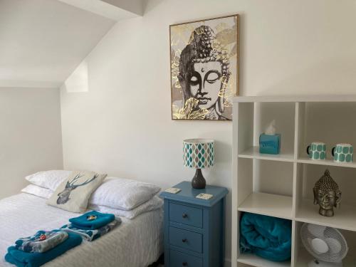 a bedroom with a bed with a blue night stand at Henley Town Rooms in Henley on Thames