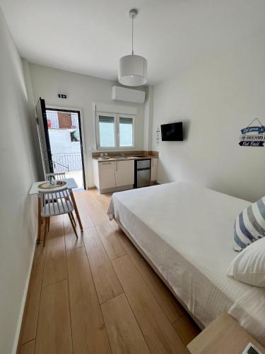a bedroom with a bed and a table and a chair at mySIVIRI in Siviri