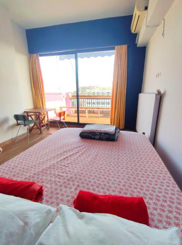 a bedroom with a large bed and a large window at SleepEasy in Athens
