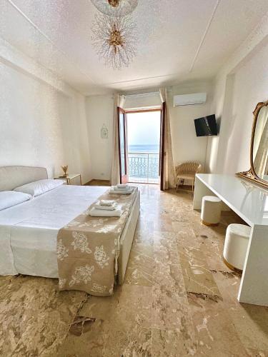 a bedroom with a large bed and a large window at The View apartment in Scilla