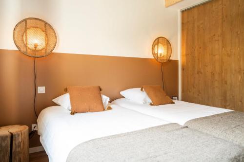 two beds sitting next to each other in a room at Gite d'exception en pleine nature in Prémanon