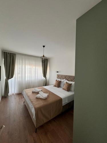 a bedroom with a large bed in a room at Venima City Center Apartment in Tivat