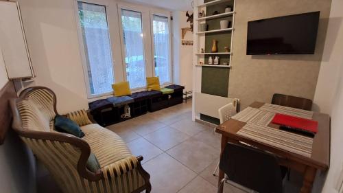 a living room with a couch and a table at Joli studio avec cour intérieure in Aix-les-Bains
