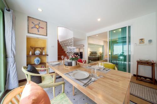a dining room with a wooden table and chairs at Bangla Patong Pool Villas with 4 Villas different designs choose fro, photo before Book in Patong Beach