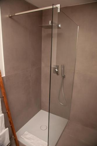 a shower with a glass door in a bathroom at Roussev Apartment - Coastal Gem - Anzio in Anzio