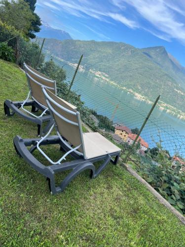 two chairs sitting on top of a hill with a view at PANORAMA,Cremia-casa LUISA in Cremia