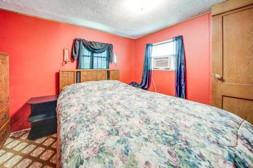 a red bedroom with a bed and a window at Andover Home Near State Park with Patio and Yard! in Hartstown