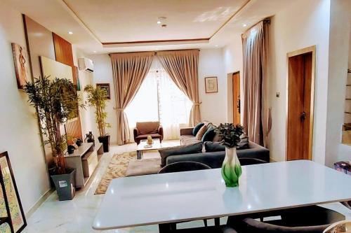 a living room with a couch and a table at 3 Bed Room Villa, Serenity in the Heart of Lekki in Sangotedo