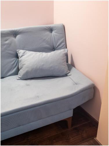 a bed with a pillow on top of it at Evena Travel Apartment in Rīga