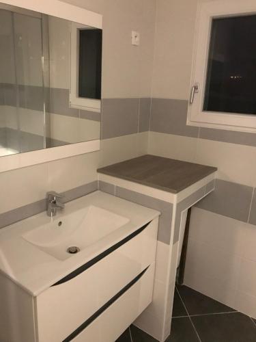 une salle de bain avec un lavabo blanc et un miroir dans l'établissement Maison avec piscine privative chauffée, à Sanary-sur-Mer