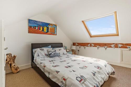 a bedroom with a bed with a comforter on it at The Pennines - Close to town beach and shops in Tenby