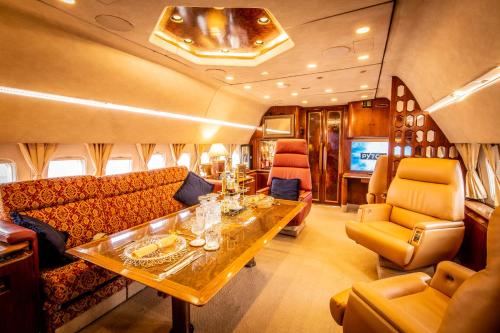a living room with a couch and a table at Boeing 727 Airliner Private Jet in Bristol