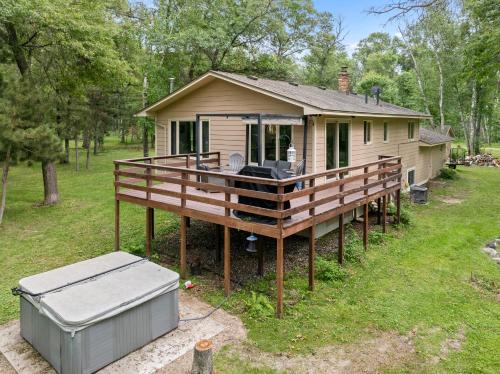 a house with a large wooden deck in a yard at Large Home with lake views and space to entertain friends in Cross Lake