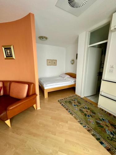 a living room with a couch and a bed at MB apartment Bled in Bled