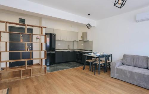 a kitchen and living room with a couch and a table at Toplish 27 in Budva