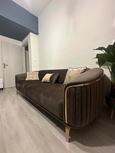 a large brown couch in a room with at N&M Apartment in Chios