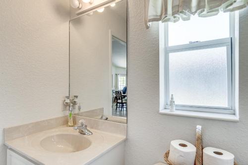 a bathroom with a sink and a mirror at Port Charlotte Home about 3 Mi to Beach and Harbor! in Port Charlotte