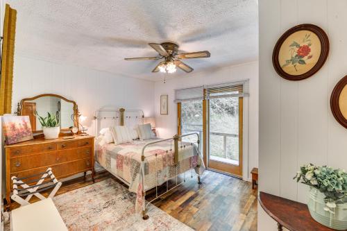 a bedroom with a bed and a ceiling fan at Charming Parsons Cabin with Grill on the Cheat River in Parsons