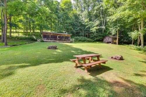 a picnic table in the middle of a field at Charming Parsons Cabin with Grill on the Cheat River in Parsons