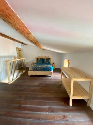 une chambre avec un lit et une table en bois dans l'établissement Le B3, parking privé, à Carcassonne
