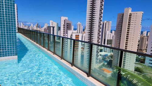 a swimming pool on the balcony of a building at FLAT Boa Viagem - 50m da Praia - Garagem GRÁTIS - 24H CHECK IN - in Recife