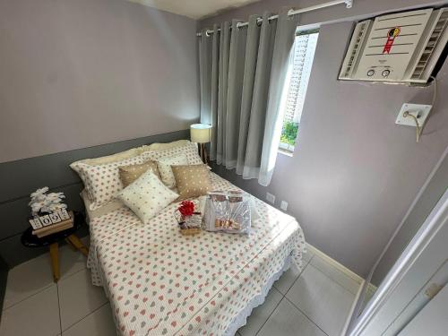 a small bedroom with a bed and a window at FLAT Boa Viagem - 50m da Praia - Garagem GRÁTIS - 24H CHECK IN - in Recife