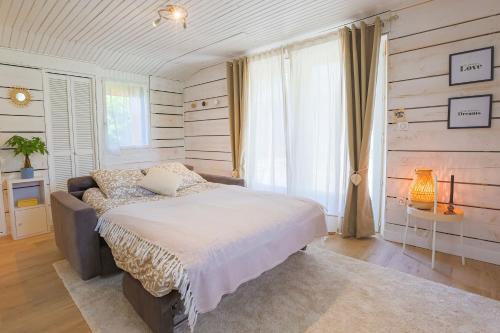 a bedroom with a large bed and a window at La parenthèse chambonnaise - chalet cosy, WIFI in Le Chambon-sur-Lignon
