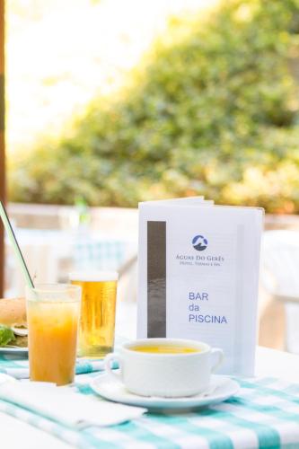 a table with a plate of food and a cup of coffee at Águas do Gerês - Hotel, Termas & Spa in Geres