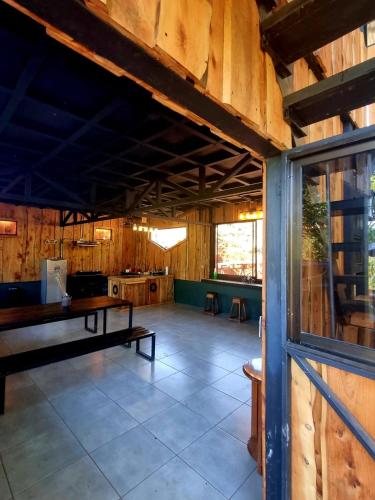 a large room with wooden walls and a table at SL Montaña Tranquila in Esperanza