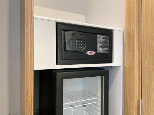 a microwave oven sitting on top of a refrigerator at Holiday Inn Express - Ankara - Airport by IHG in Ankara