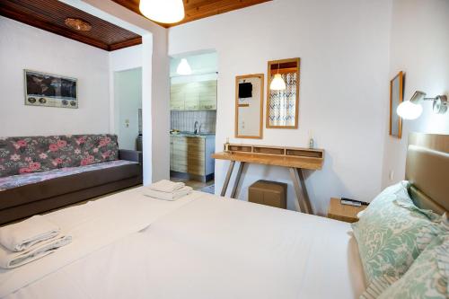 a bedroom with a bed and a living room at Emilia's House in Astris