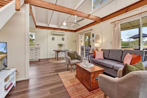 a living room with a couch and a table at Bracken Ridge Vineyard in Rothbury