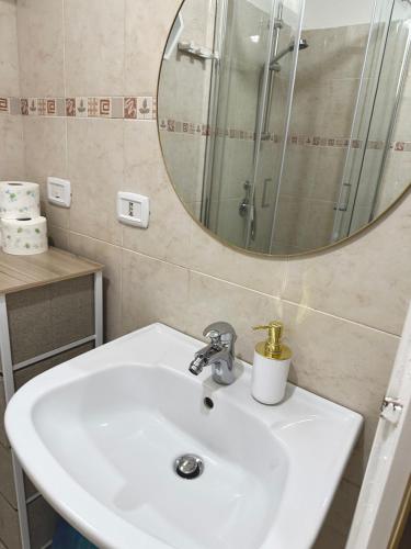 a bathroom with a sink and a mirror at The View apartment in Scilla