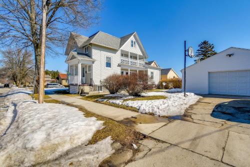 a white house with snow on the driveway at Lake Michigan Vacation Rental 1 Block to Marina! in Manitowoc