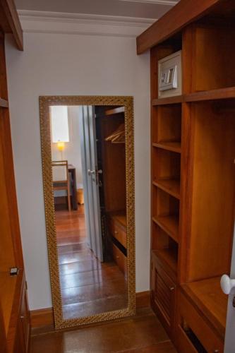 a mirror in a room with a closet and a hallway at Casa Simone Pousada in Paraty