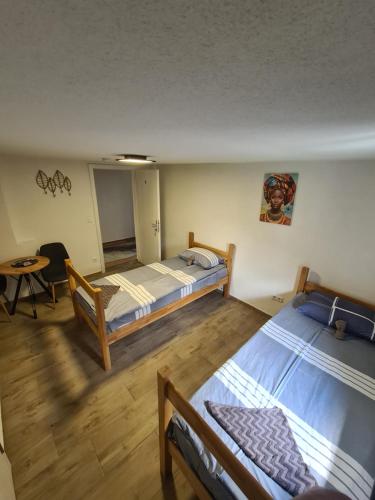 a room with two beds and a table in it at No name in Jajce
