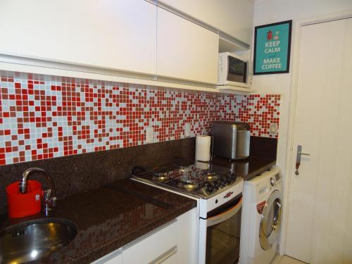 a kitchen with a sink and a stove top oven at Casa Estrela do Mar in Angra dos Reis
