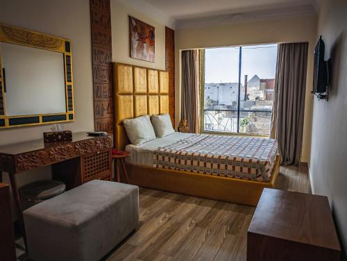 a hotel room with a bed and a window at Jimmy Pyramids Hotel in Cairo