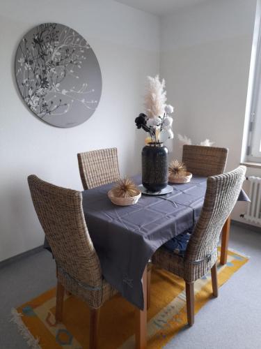 a dining room table with a blue table cloth and chairs at Lakeview by Bea in Immenstaad am Bodensee