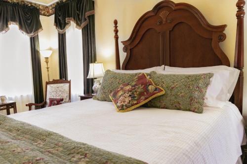 a bedroom with a large bed with a wooden headboard at Weaverville Hotel in Weaverville