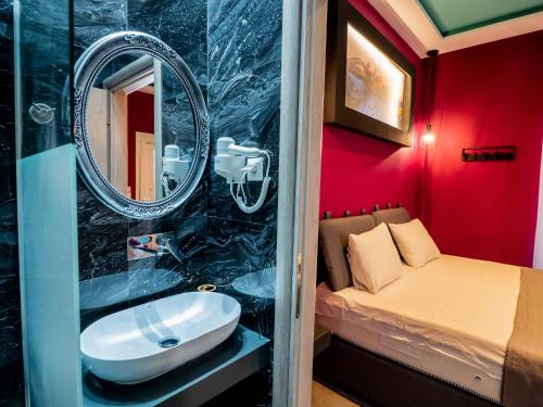 a bathroom with a sink and a bed in a room at ThassCities Casa Studios in Limenas