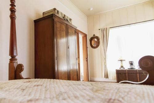 a bedroom with a bed and a cabinet and a window at Weaverville Hotel in Weaverville