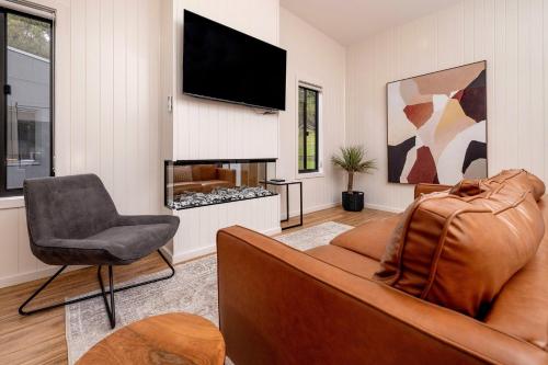 a living room with a couch and a fireplace at BIG4 Wye River Holiday Park in Wye River
