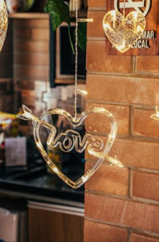 a heart is hanging on a brick wall at Pousada Grom's Village in Campos do Jordão
