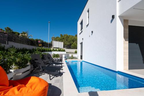 a swimming pool in the backyard of a house at Family friendly house with a swimming pool Bibinje, Zadar - 23364 in Bibinje