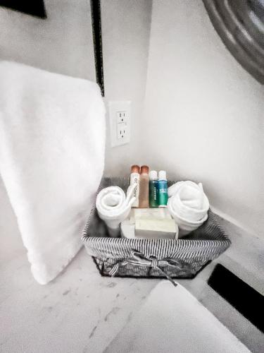 a basket of towels and other items in a bathroom at The Riverscape at Gruene in New Braunfels