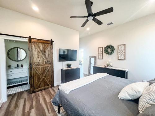 a bedroom with a bed and a ceiling fan at The Riverscape at Gruene in New Braunfels